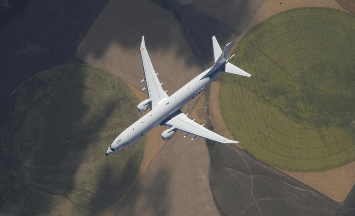 A maritime patrol aircraft photographed from directly overhead in flight.